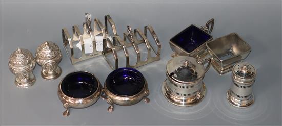A pair of George V silver toast racks, Sheffield, 1934 and seven assorted silver condiments including Georgian.